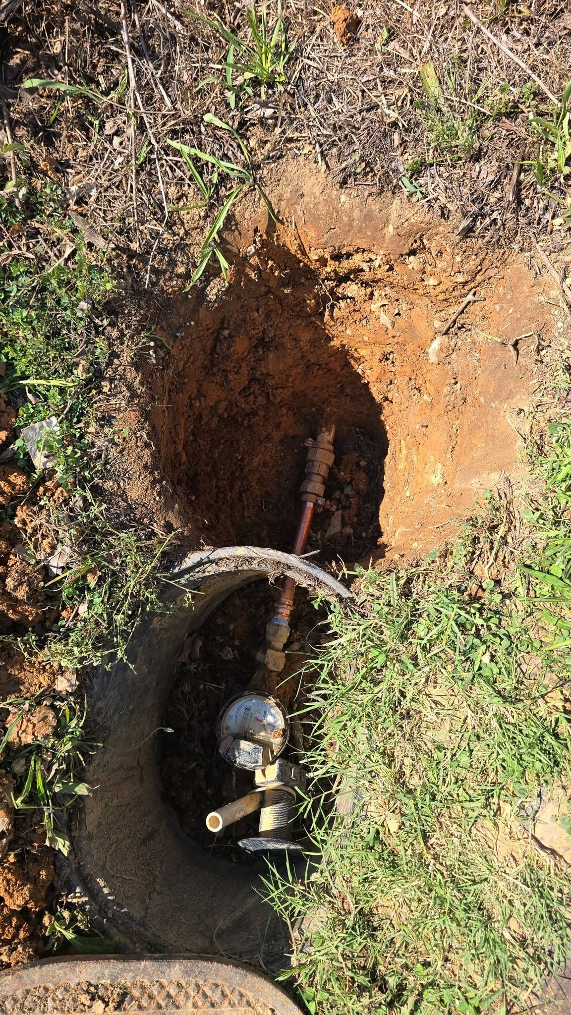 Copper water service line repaired in a trench just past the water meter